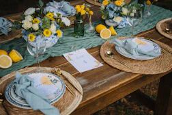 Table setting with lemons and floral arrangements.