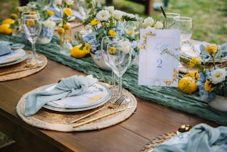 Elegant table setting with floral arrangements and lemons.