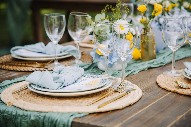 Table setting with plates, glasses, and flowers.