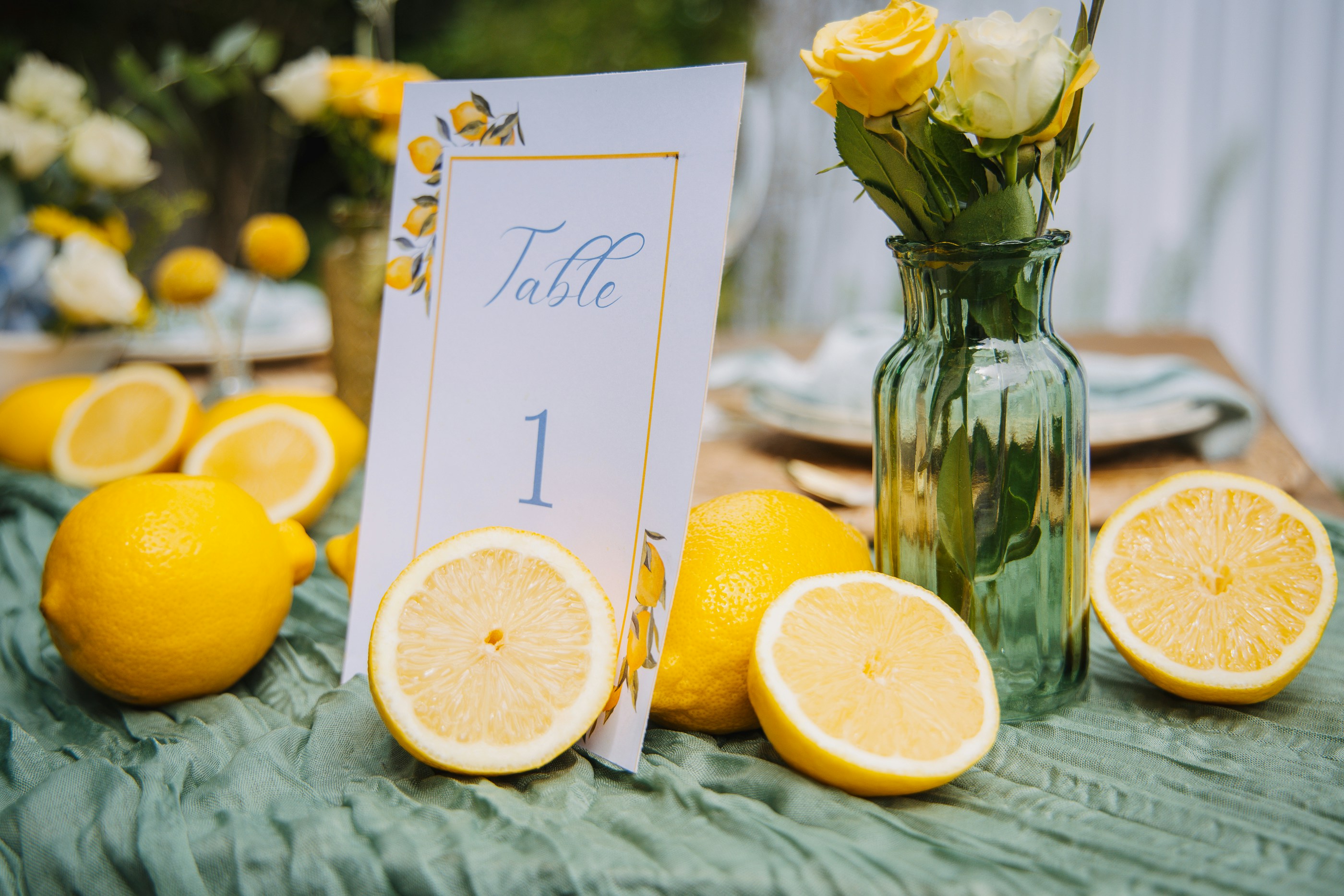 Table setting with lemons and yellow flowers