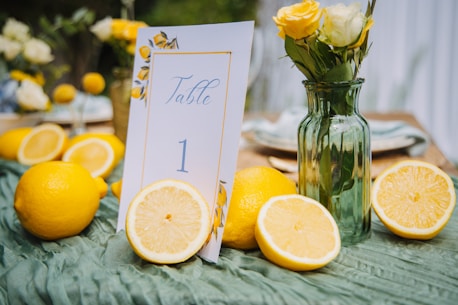 Table setting with lemons and yellow flowers