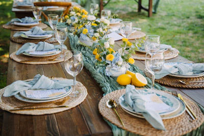 Outdoor table setting with floral centerpiece and lemons
