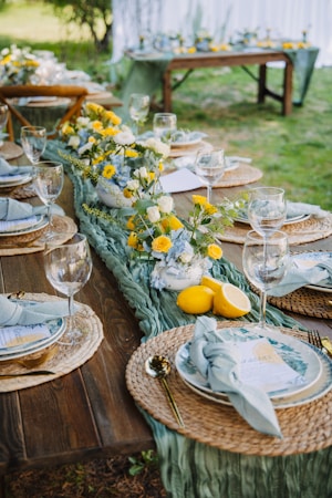 A beautifully set outdoor dining table with floral centerpiece.