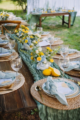 A beautifully set outdoor dining table with floral centerpiece.
