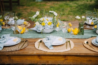 Outdoor table setting with floral centerpiece and lemons