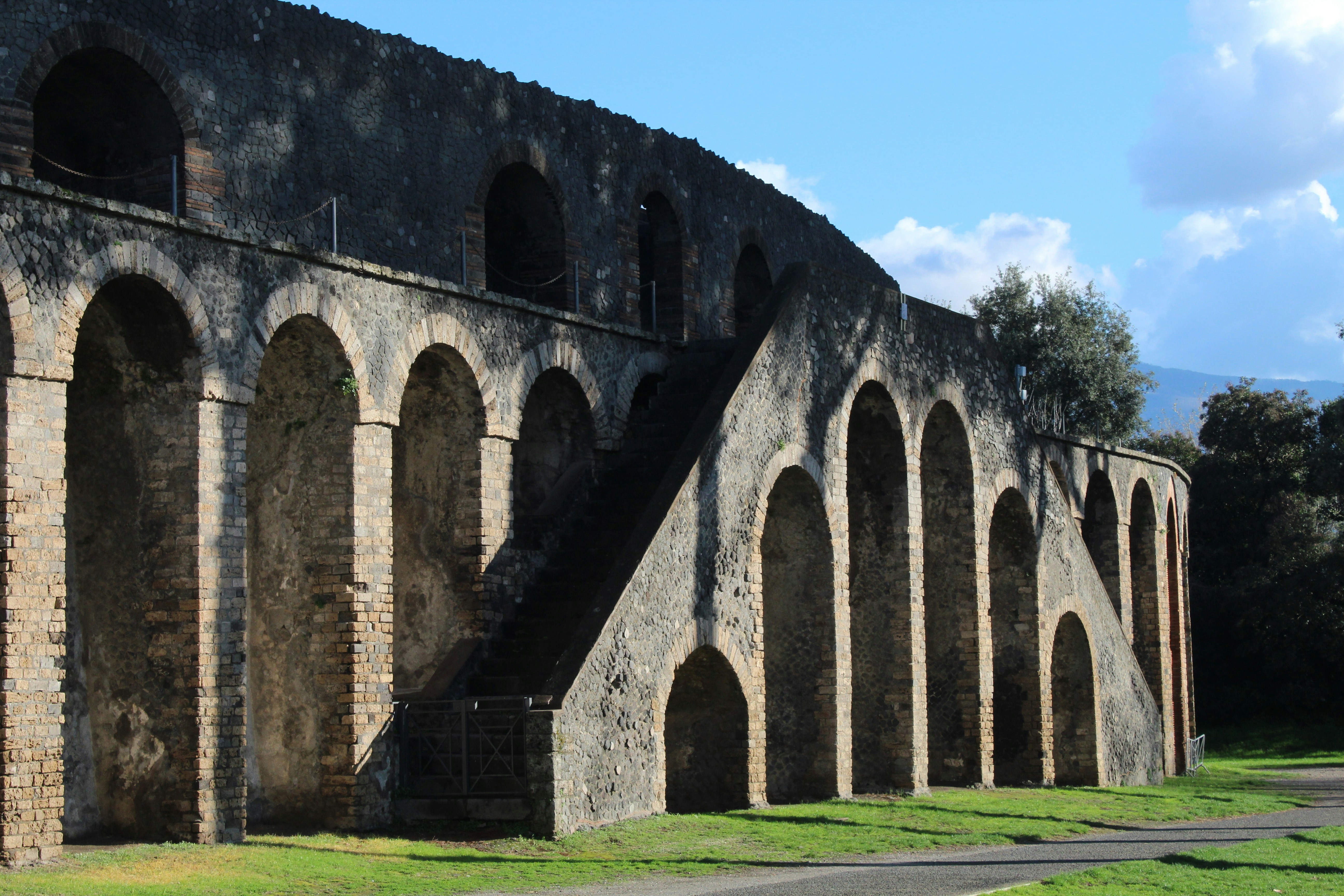 Ancient stone arches and stairs with green grass
