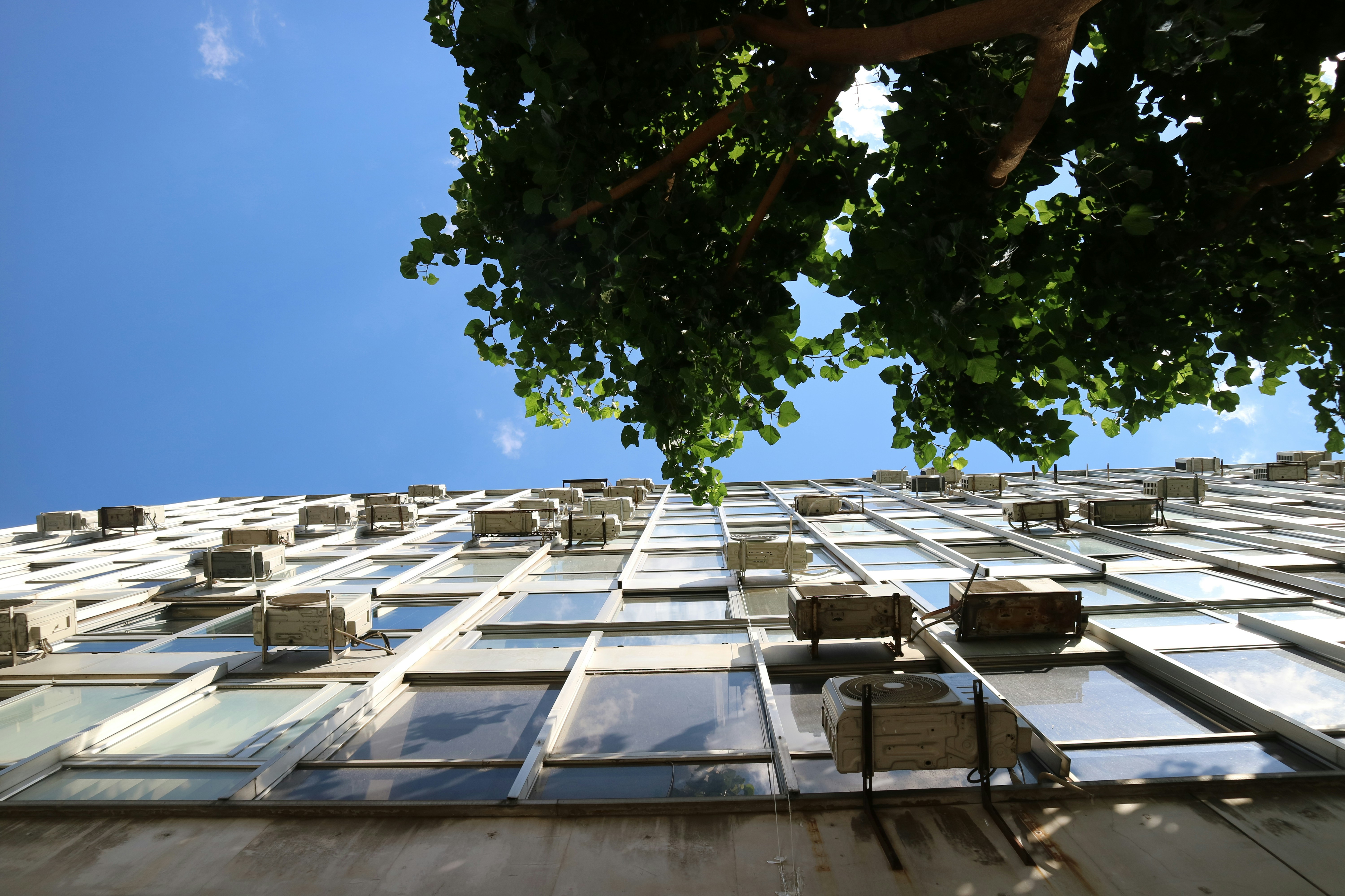 Building facade with many windows under blue sky.