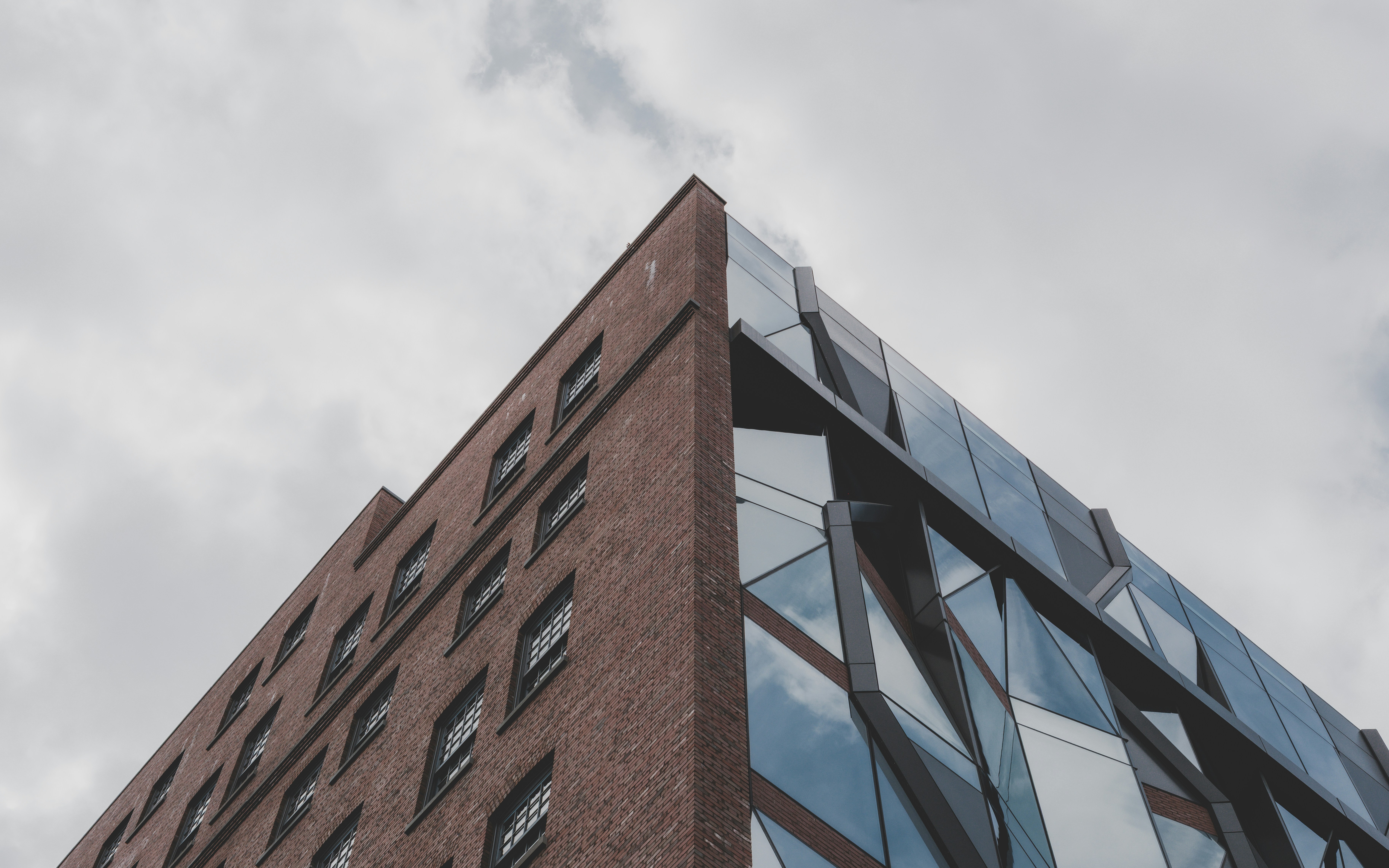 Modern building with brick and glass facade.