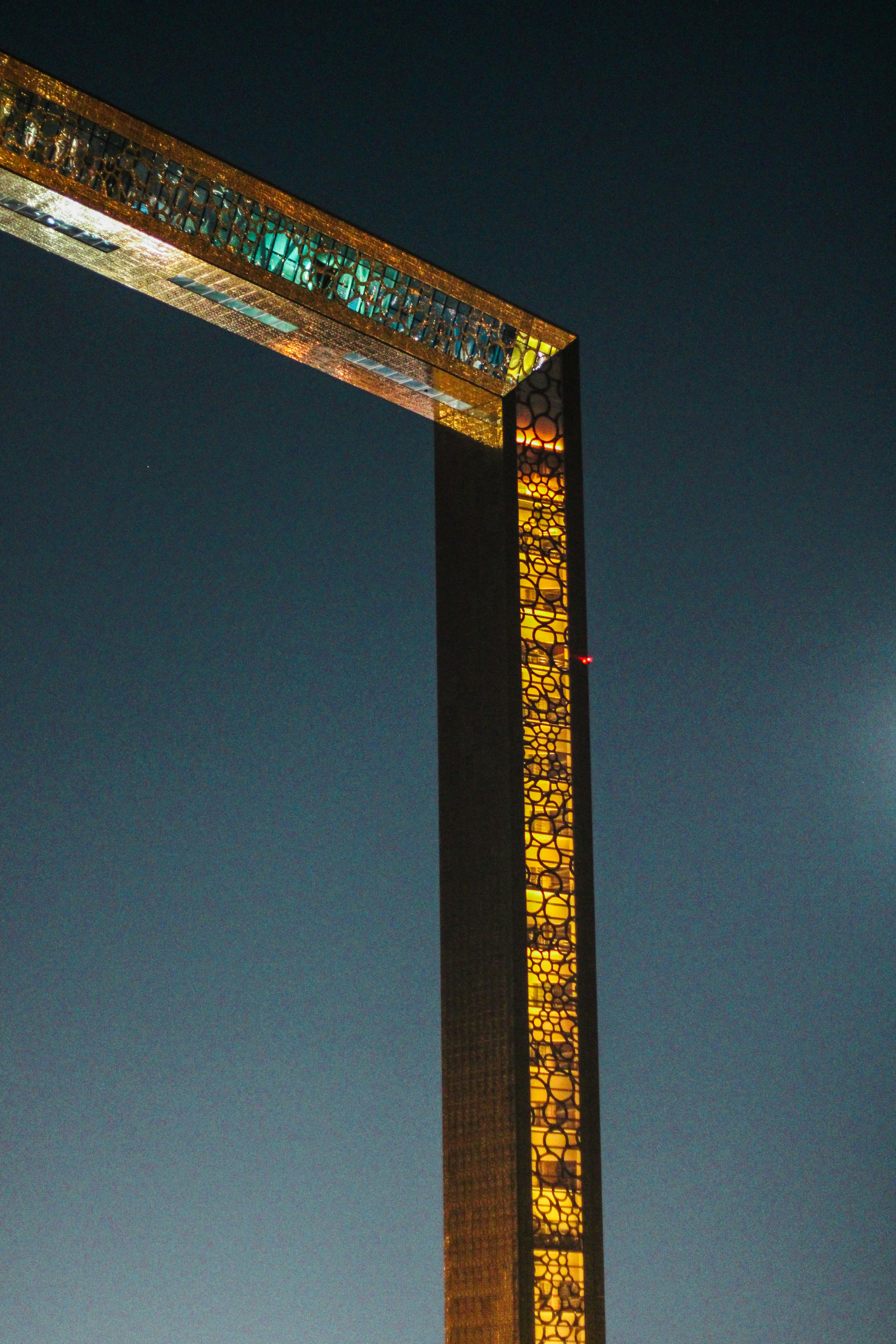 Modern illuminated skyscraper against a night sky