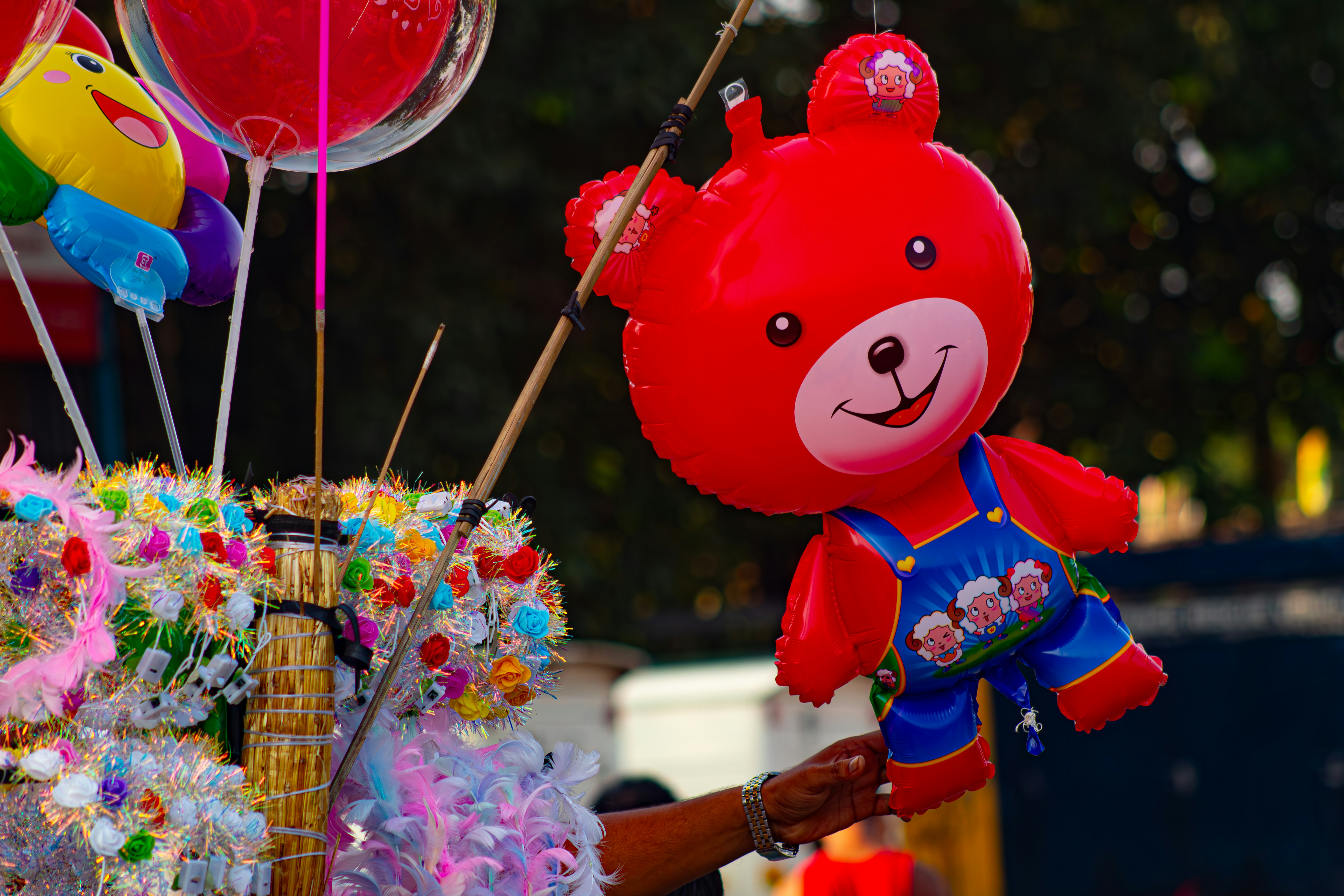 Red teddy bear balloon with other colorful balloons