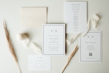 Wedding stationery suite with neutral ribbon and dried flowers.