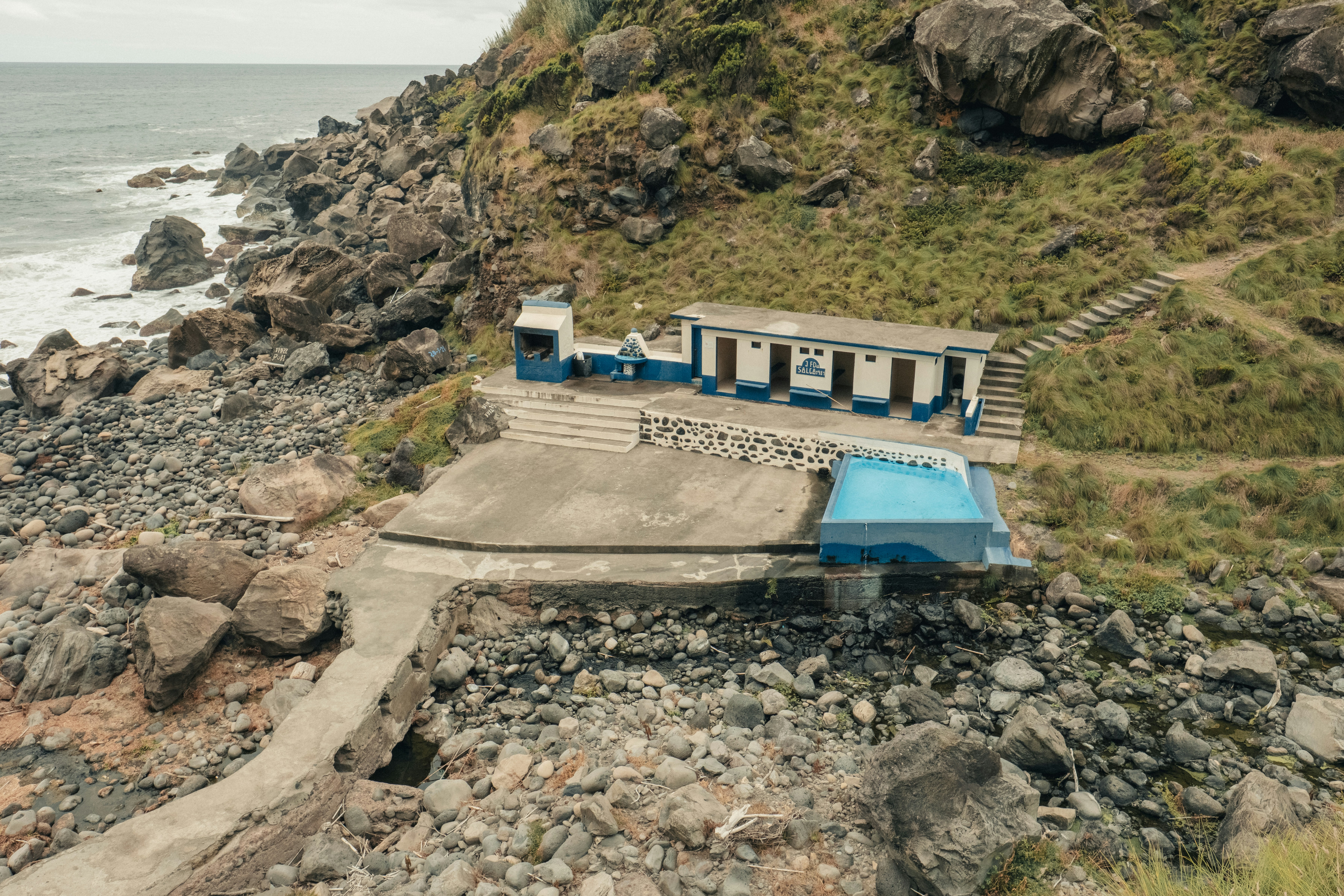 Gebäude mit Pool an felsiger Küste in der Nähe des Ozeans