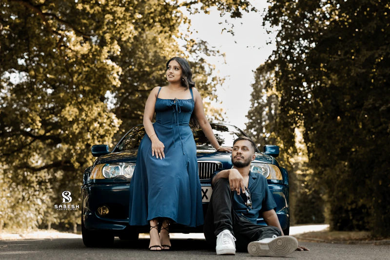 An Adelaide Sugar Daddy and Sugar Baby posing by a luxury car on a tree-lined road.