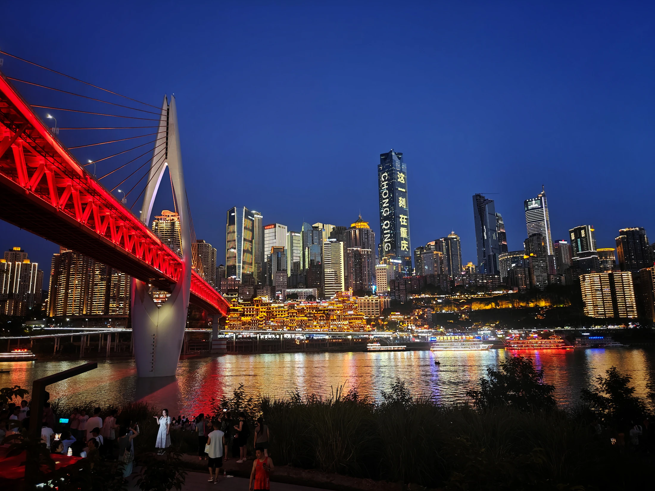 Qiansimen Bridge and Hongyadong glowing across the river at dusk