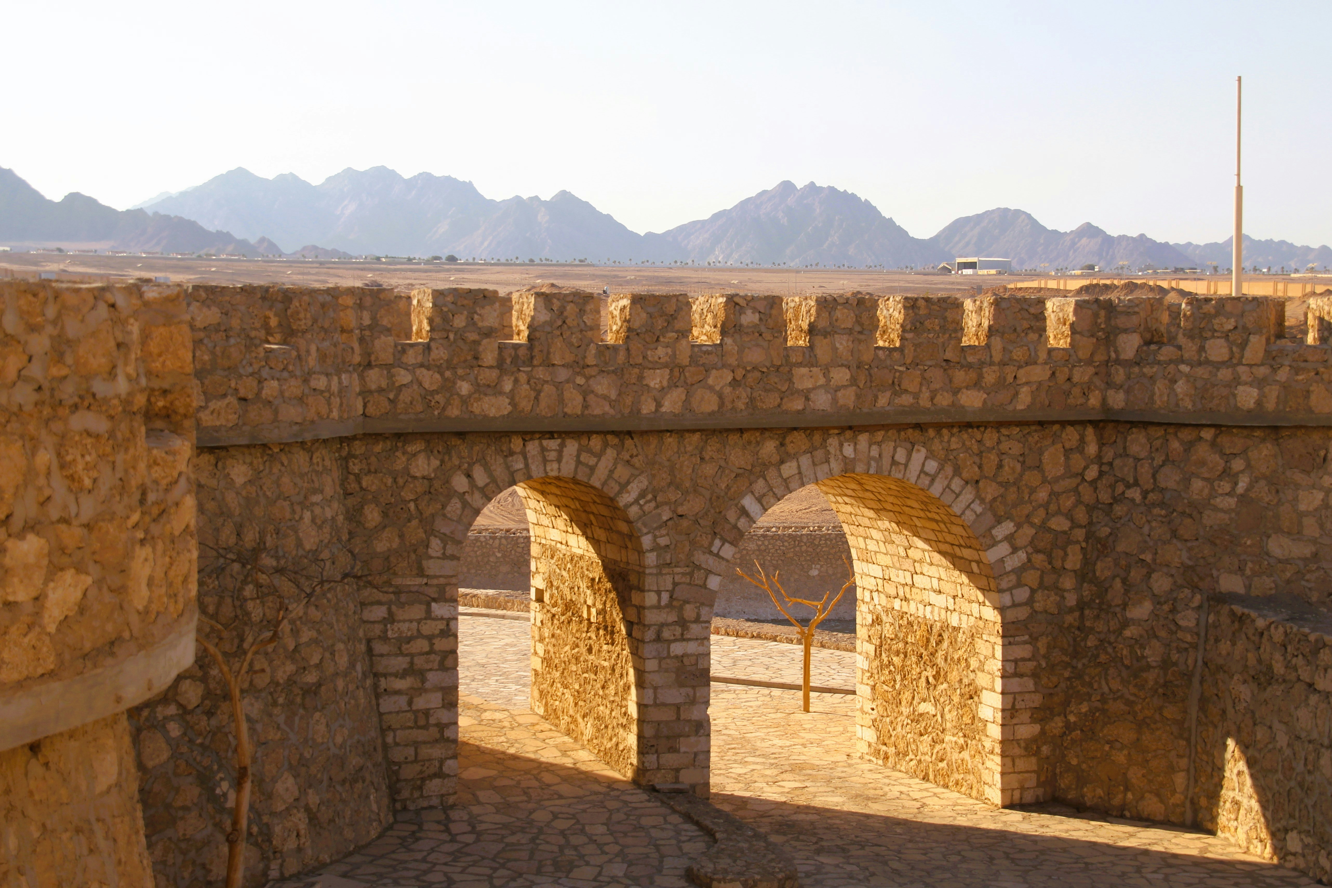 Ancient stone gateway with mountains in background
