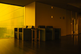 Modern waiting area with yellow lighting and seating.