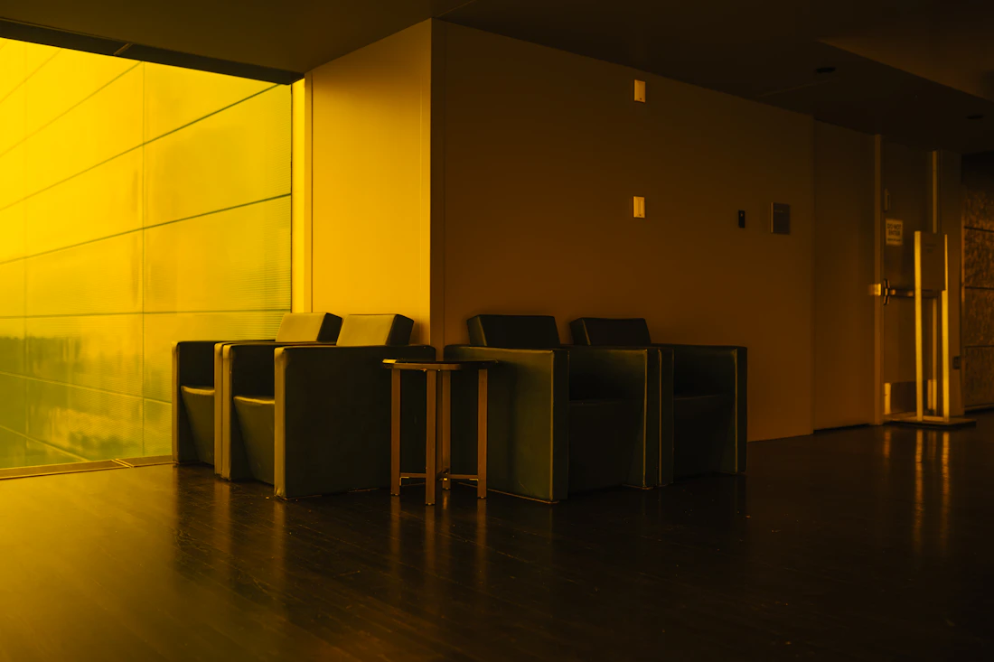 A modern waiting area lit in warm amber tones