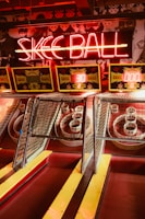 Skee-ball machines with neon sign