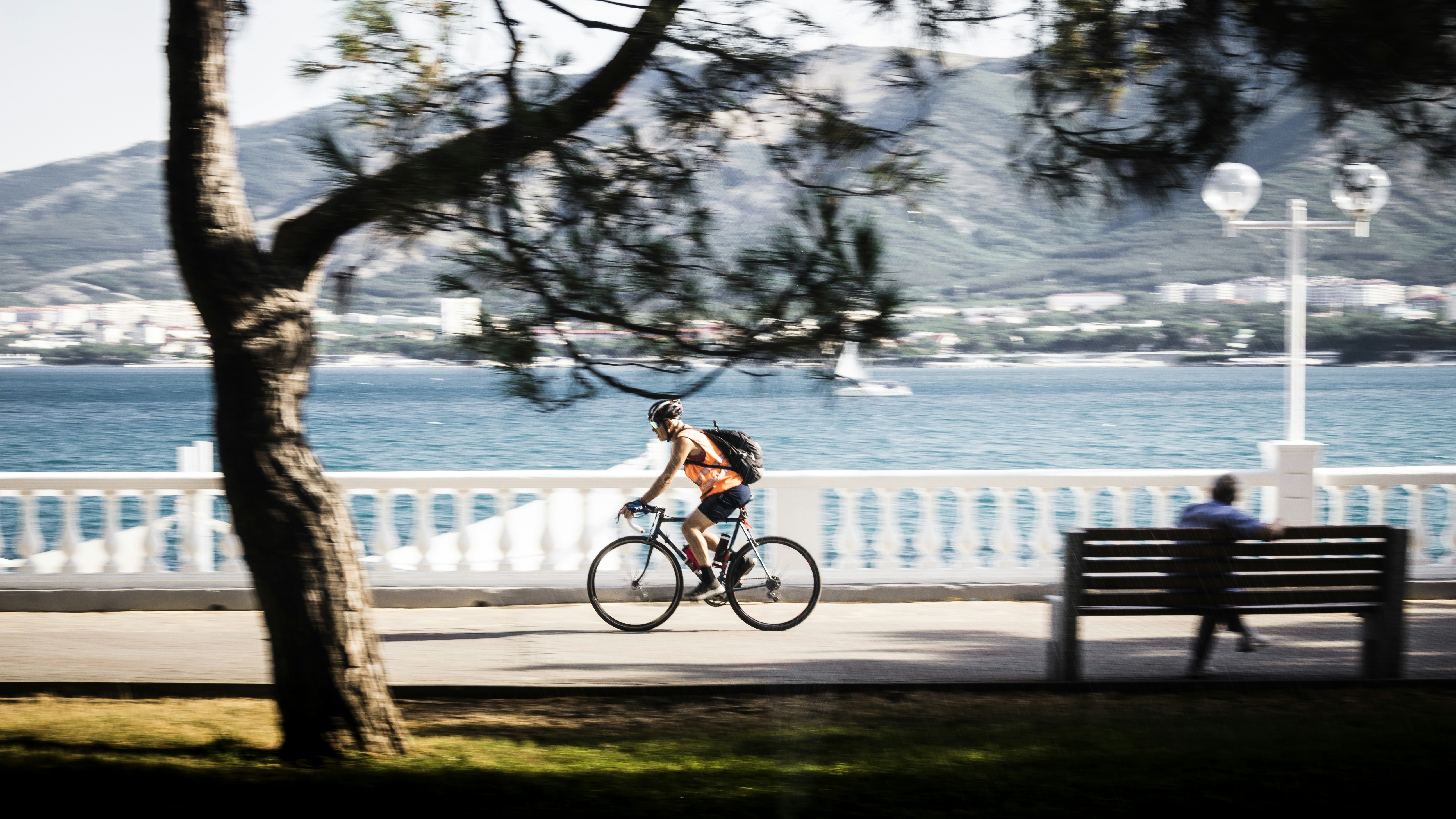 Man cycling along the waterfront promenade