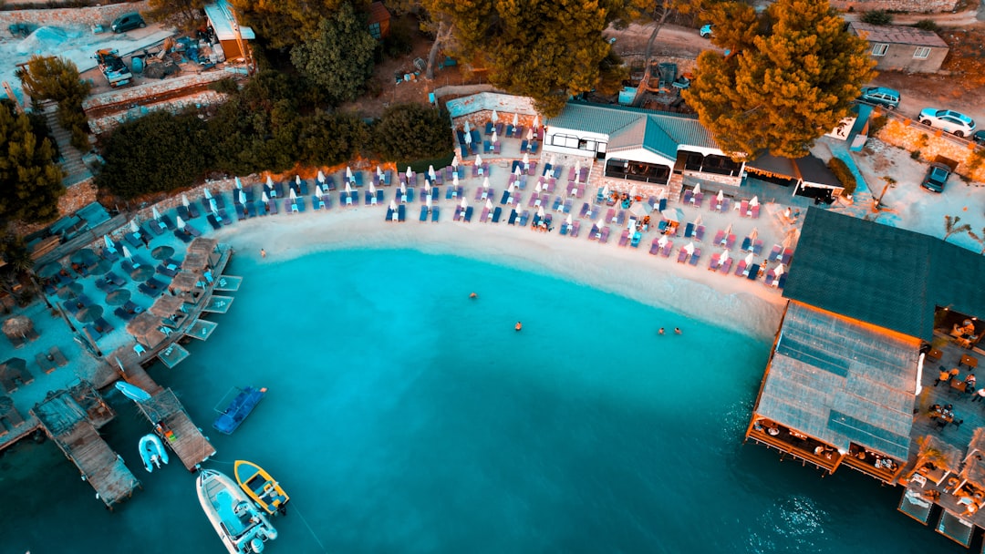 Aerial view of people gathered on a beach near buildings.