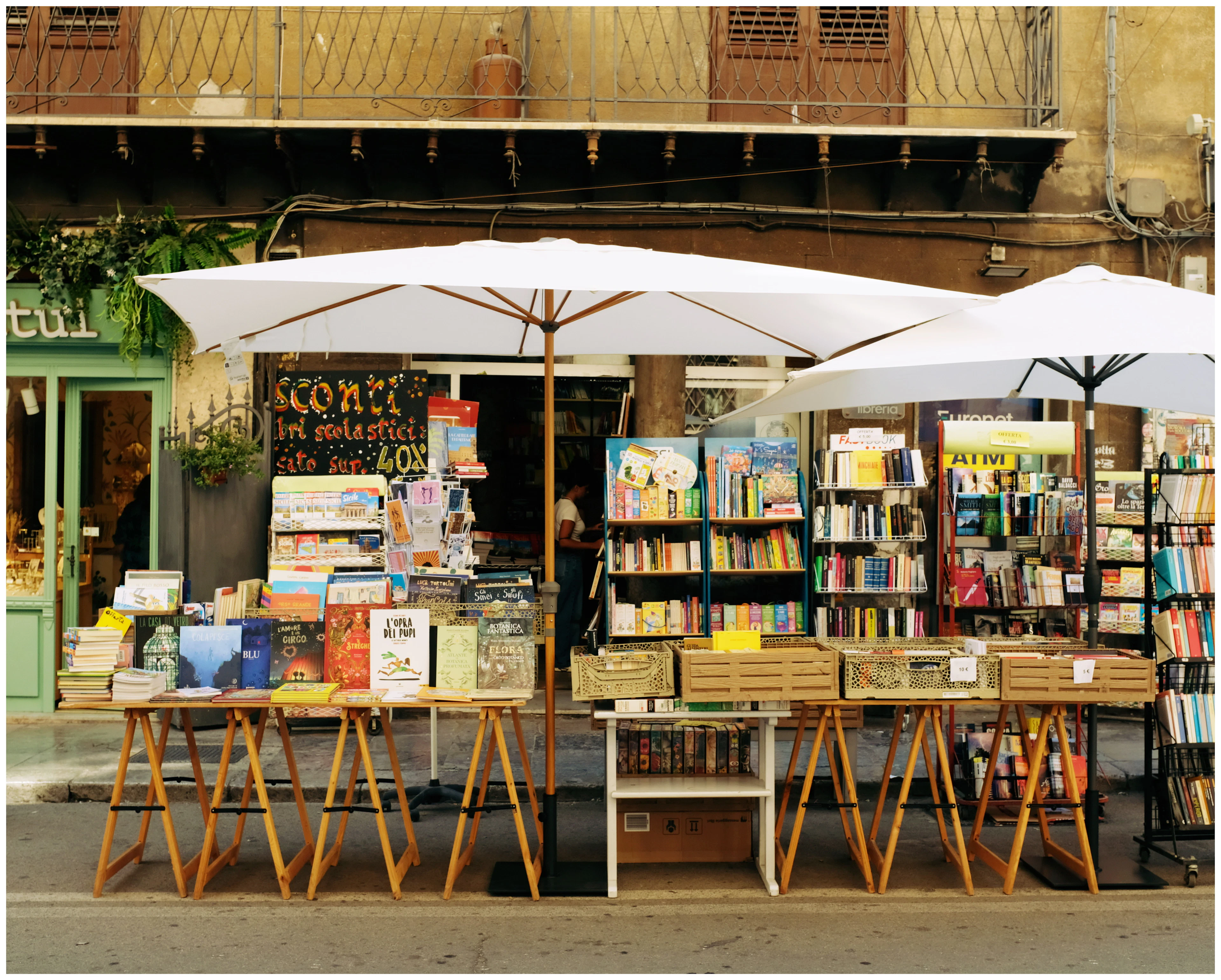 Books displayed at an outdoor bookshop, one of the places readers can discover and buy a title