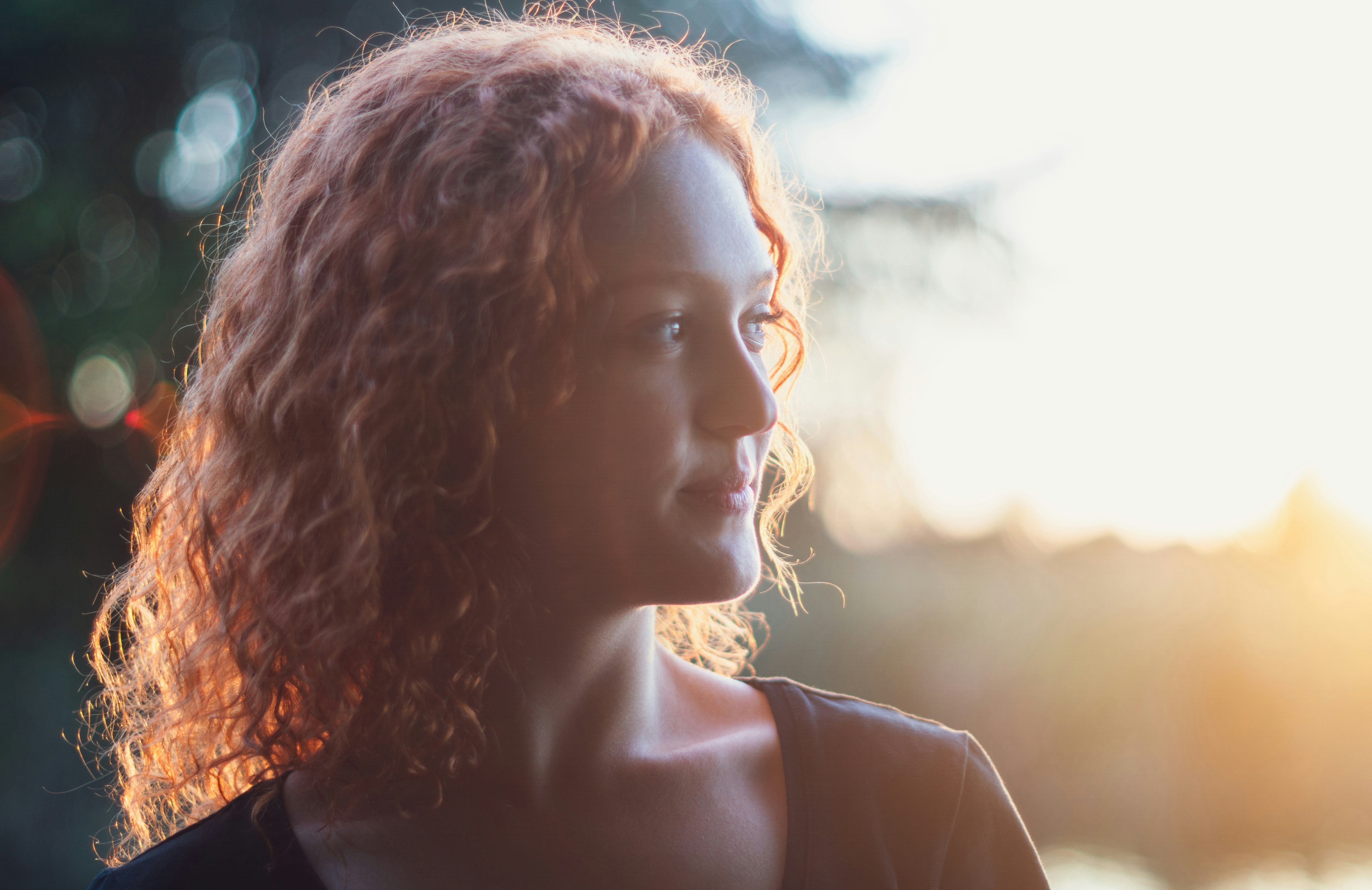 Red-haired woman in sunlight