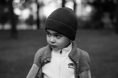 Young boy in beanie and jacket outdoors