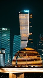 Modern illuminated skyscrapers at night in a city.