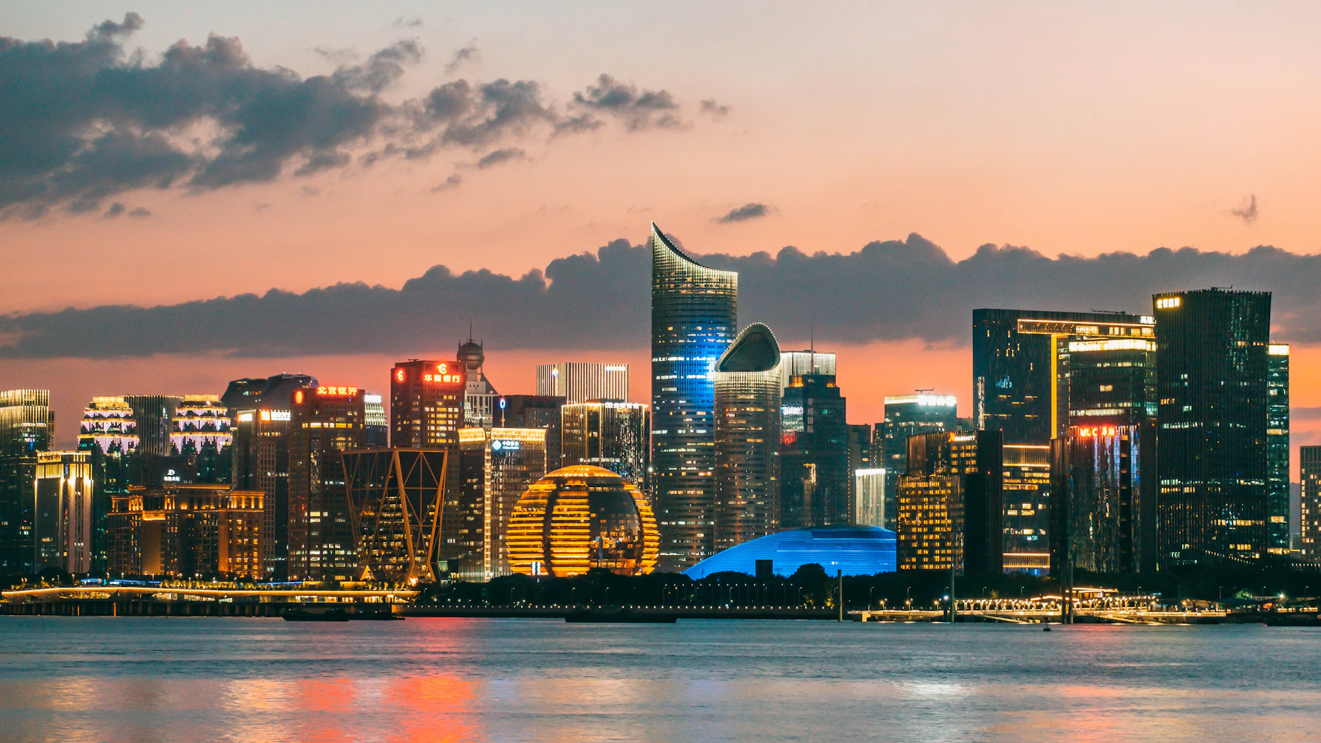 Modern cityscape with illuminated skyscrapers at dusk