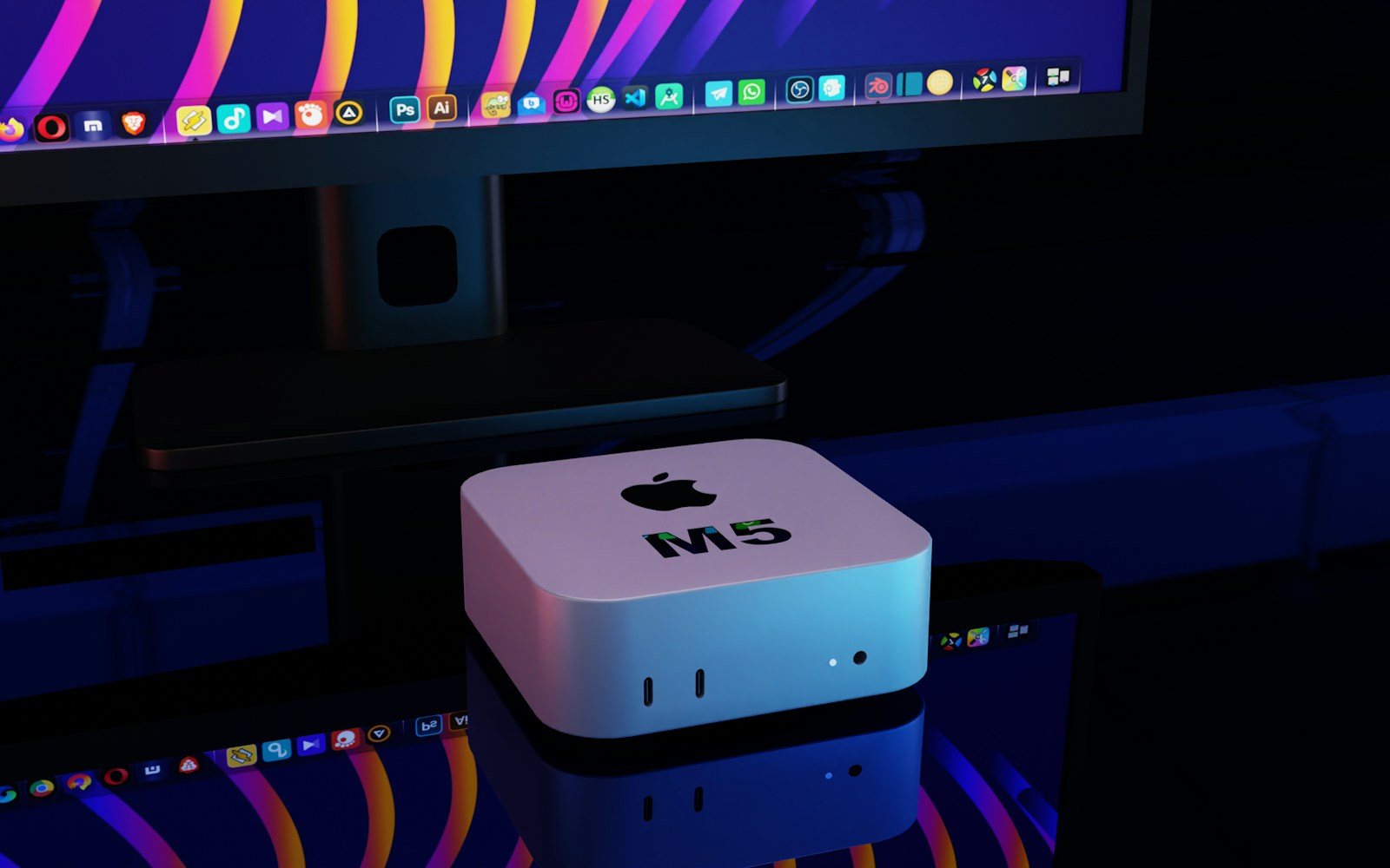 Compact silver desktop computer beside a monitor