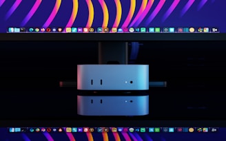 Two silver computer docks stacked on a black surface.