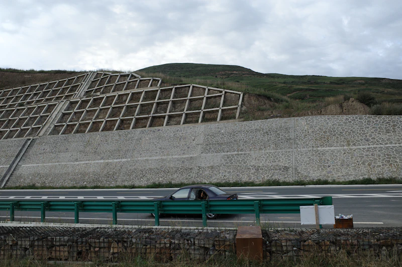 Engineered retaining wall along a graded roadway