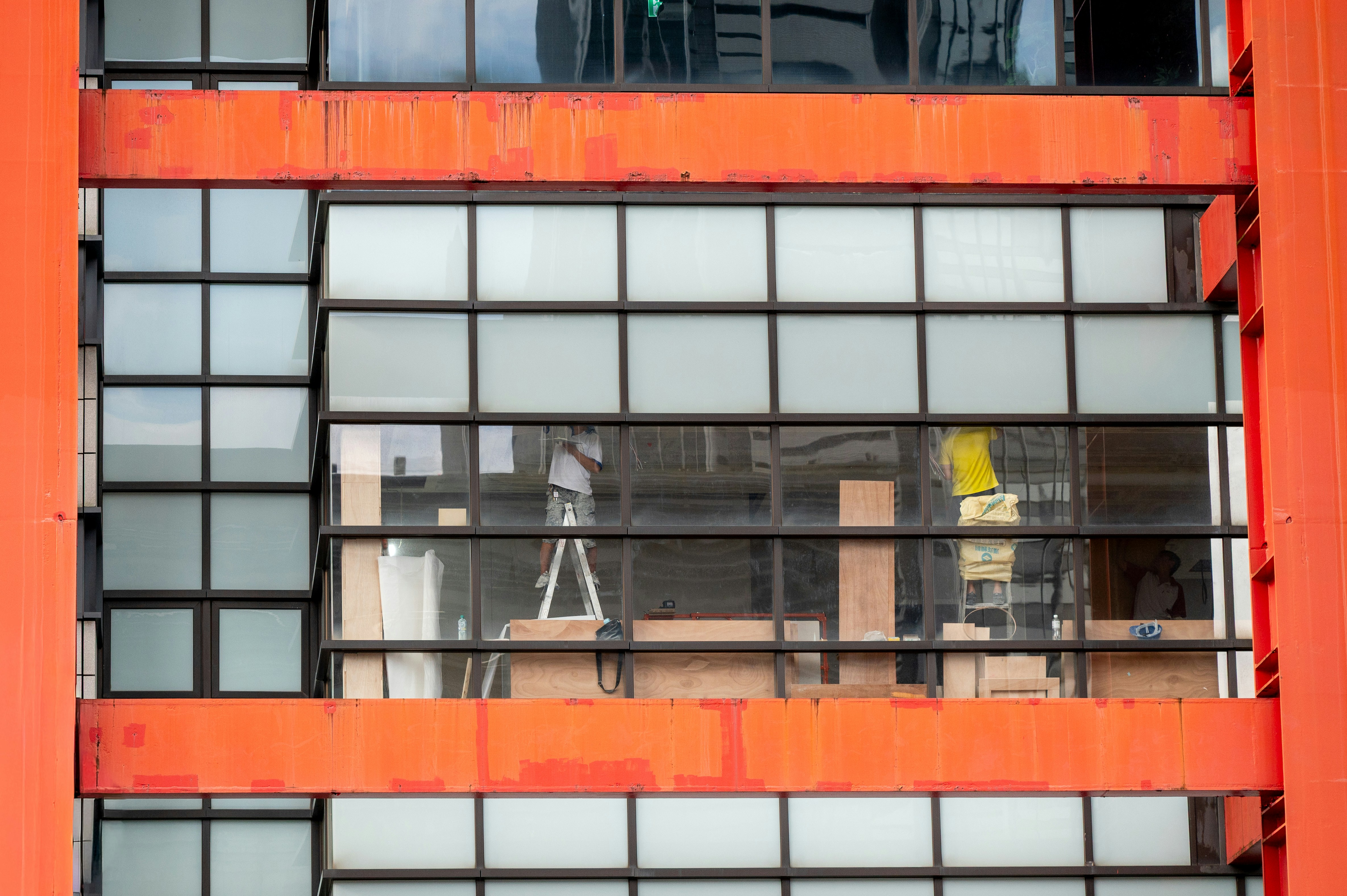 Modern building exterior with orange accents and glass windows
