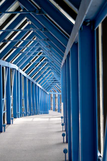 Blue metal walkway with angled roof structure
