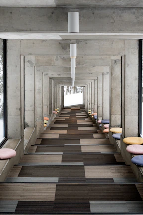 Concrete hallway with colorful cushions and patterned floor