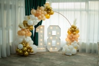 Illuminated number 18 with balloon decorations