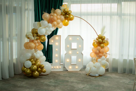Illuminated number 18 with balloon decorations