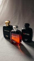 Three perfume bottles on a light surface.