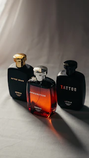 Three perfume bottles on a light surface