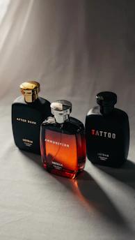 Three perfume bottles on a light surface