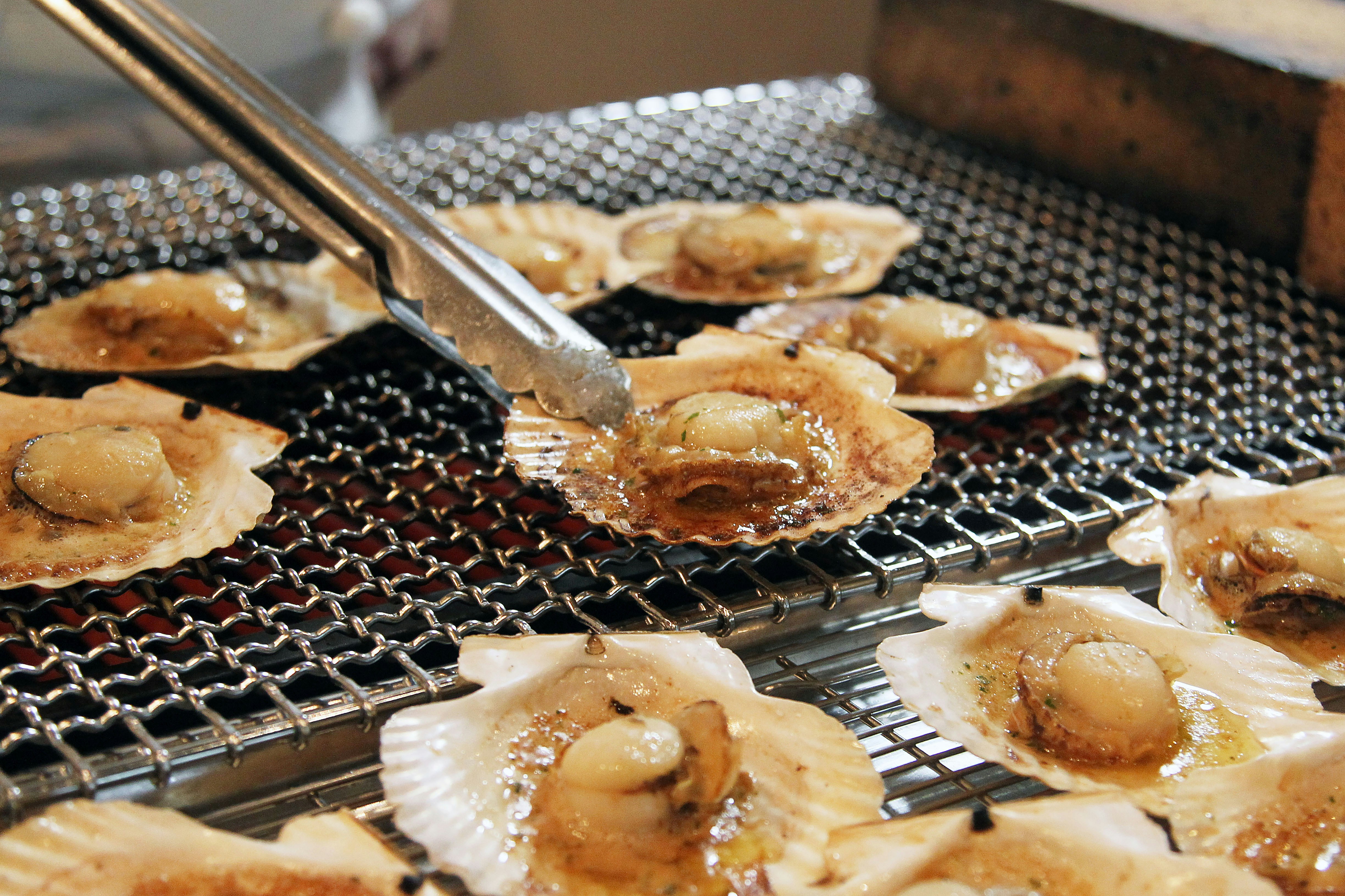Image of grilled calamari skewers being prepared on a barbecue