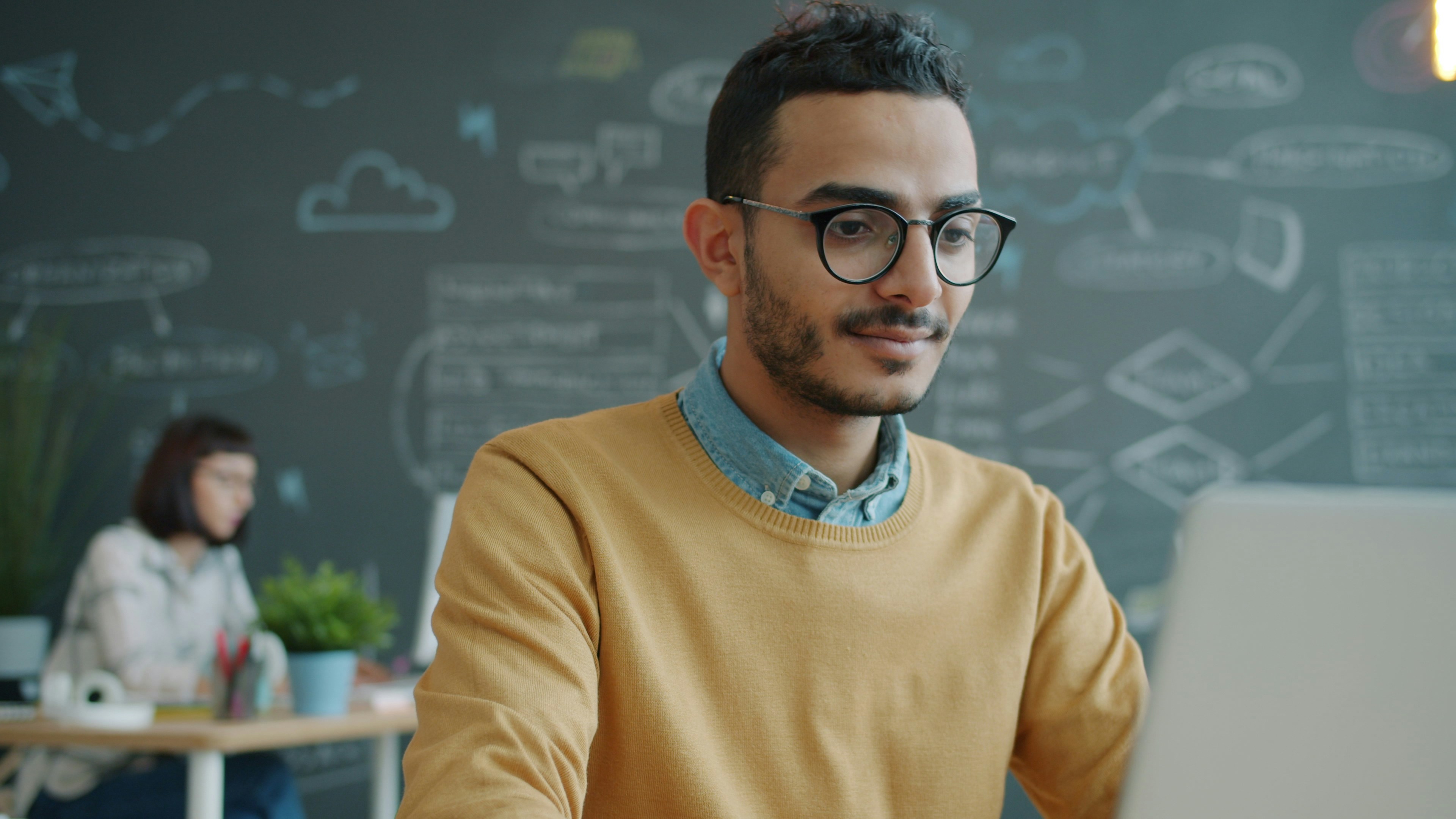 Happy office worker using laptop