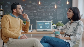 Two colleagues discussing ideas in a modern office.