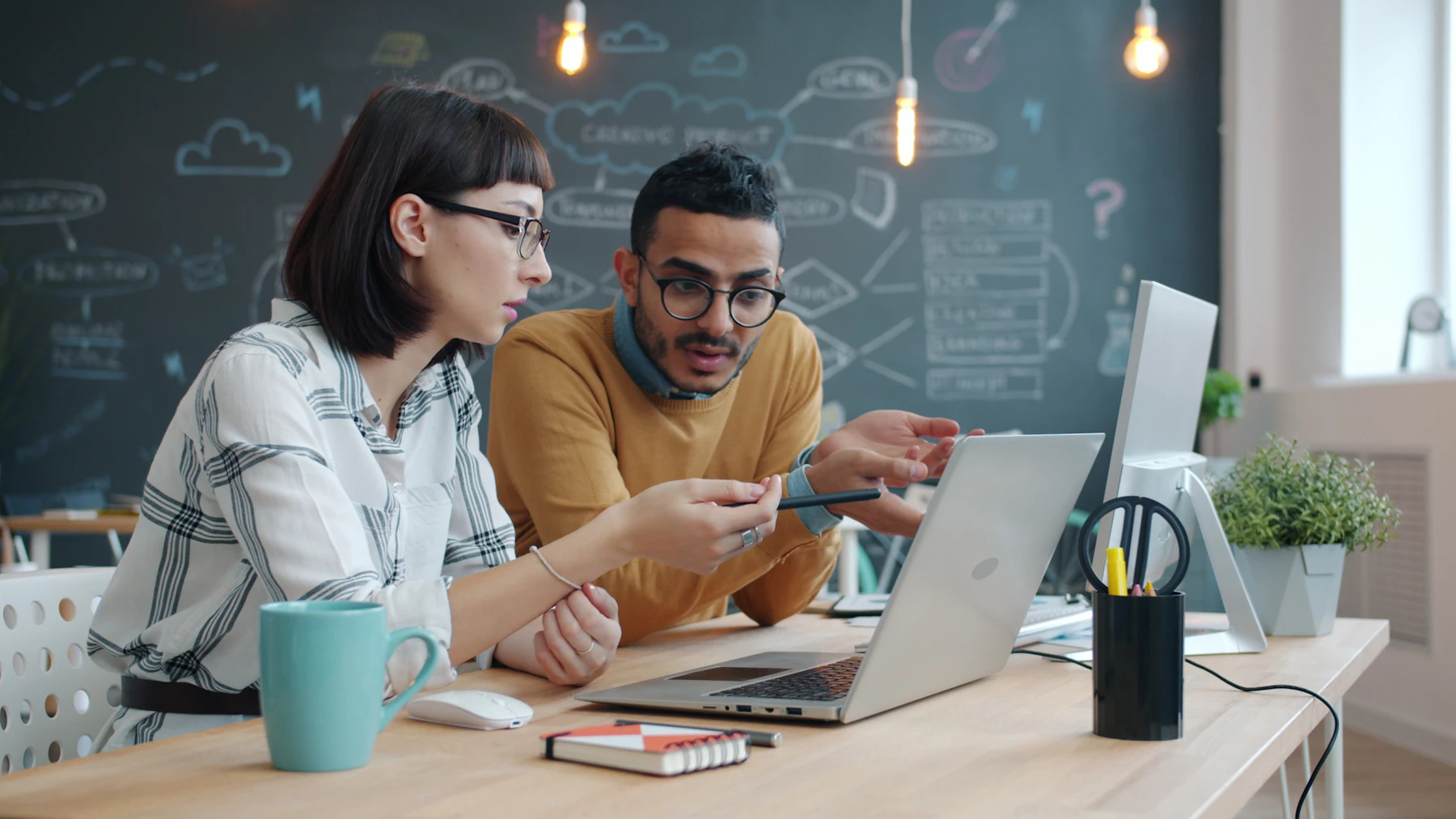 Business team reviewing data and analytics on a laptop