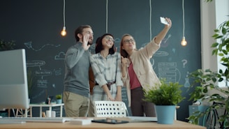 Three colleagues taking a selfie in the office