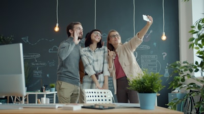 Three colleagues taking a selfie in the office