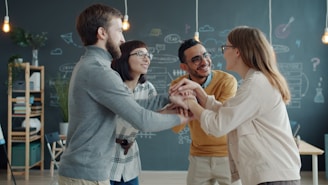 Diverse team celebrates success with a huddle.