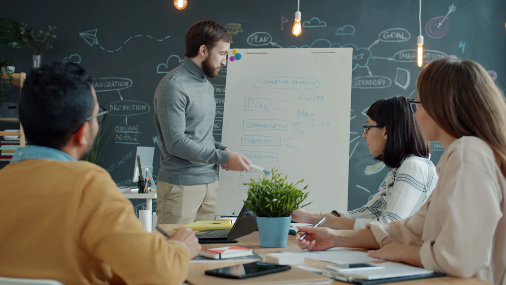 Team mapping out a technology plan on a whiteboard