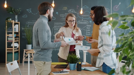 Colleagues collaborating around a table in an office.
