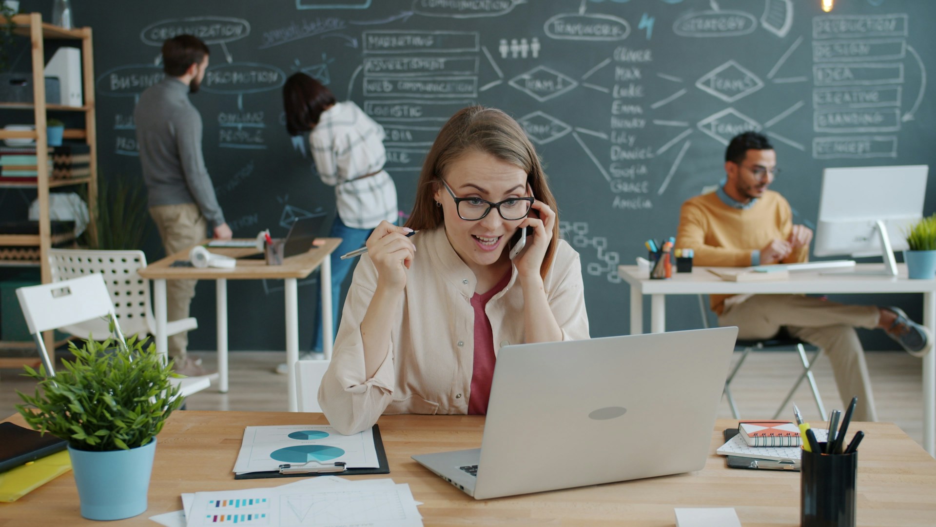Woman celebrating success while on a business call.